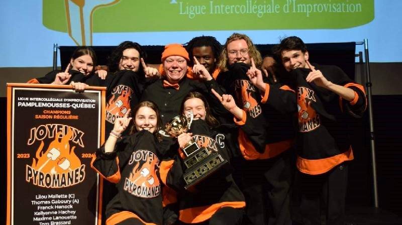 L'équipe d'impro avec les médailles souriant à la caméra. 